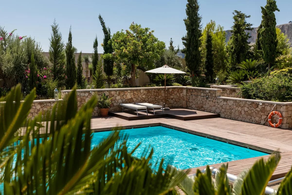 Pool waterline and deck edge with clear water reflecting desert sun
