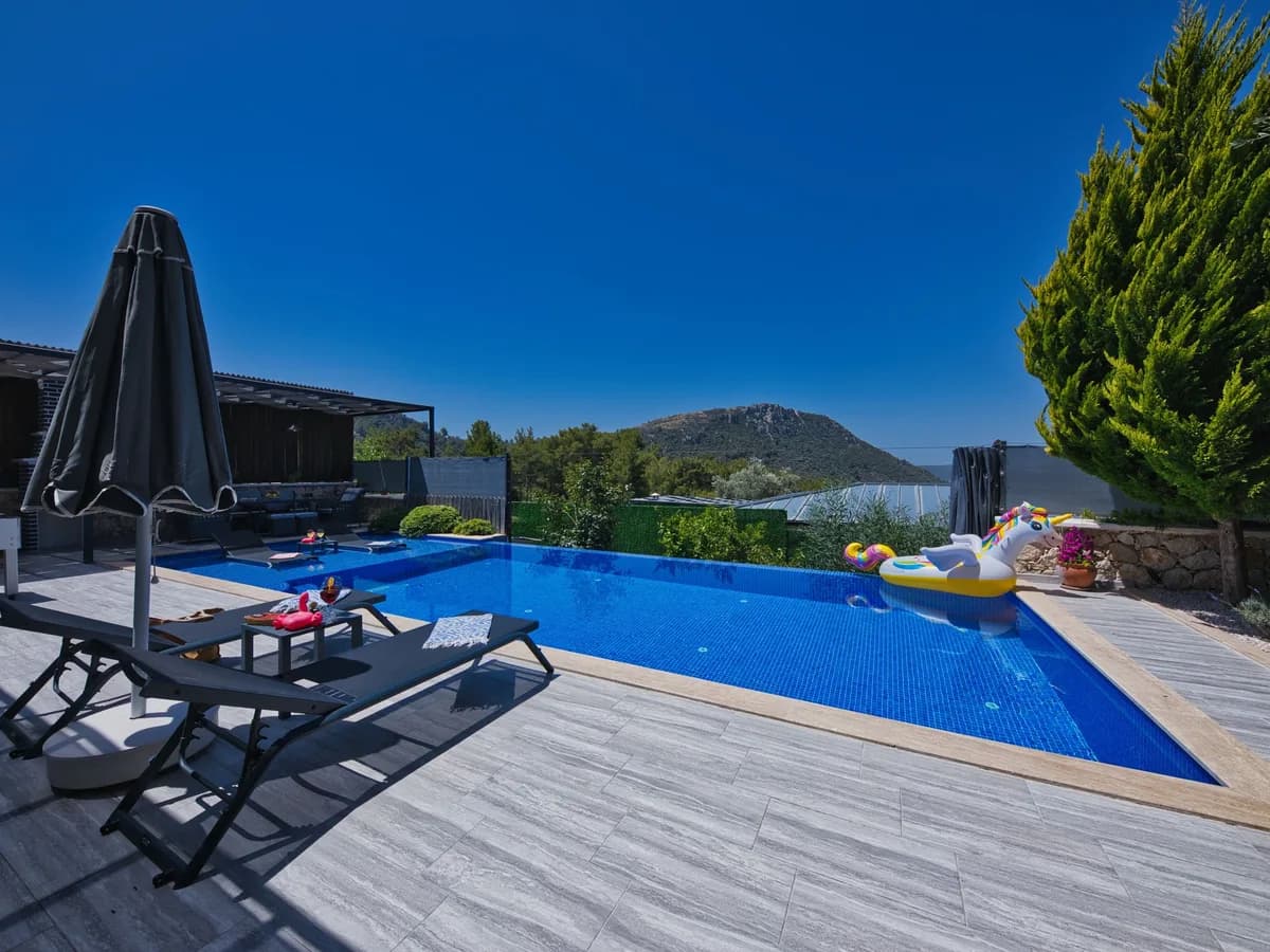 Luxury desert-style geometric pool with clear water and mountain views, ready for weekly care